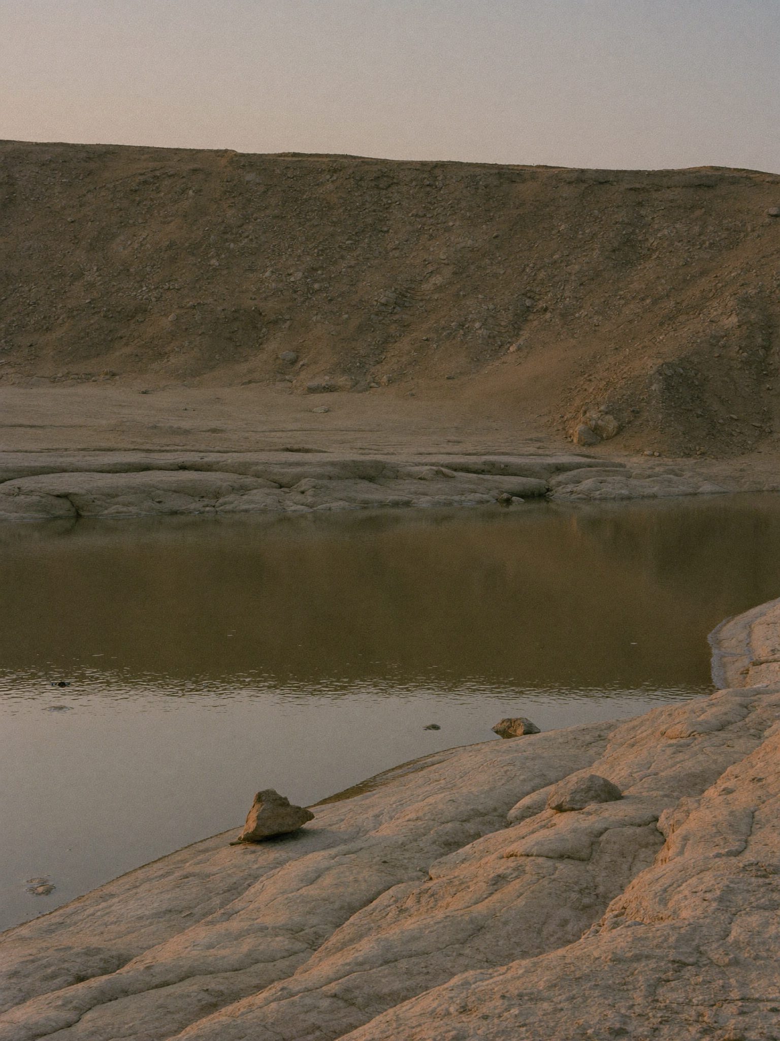 River water carving through geological strata, symbolising layered financial verification